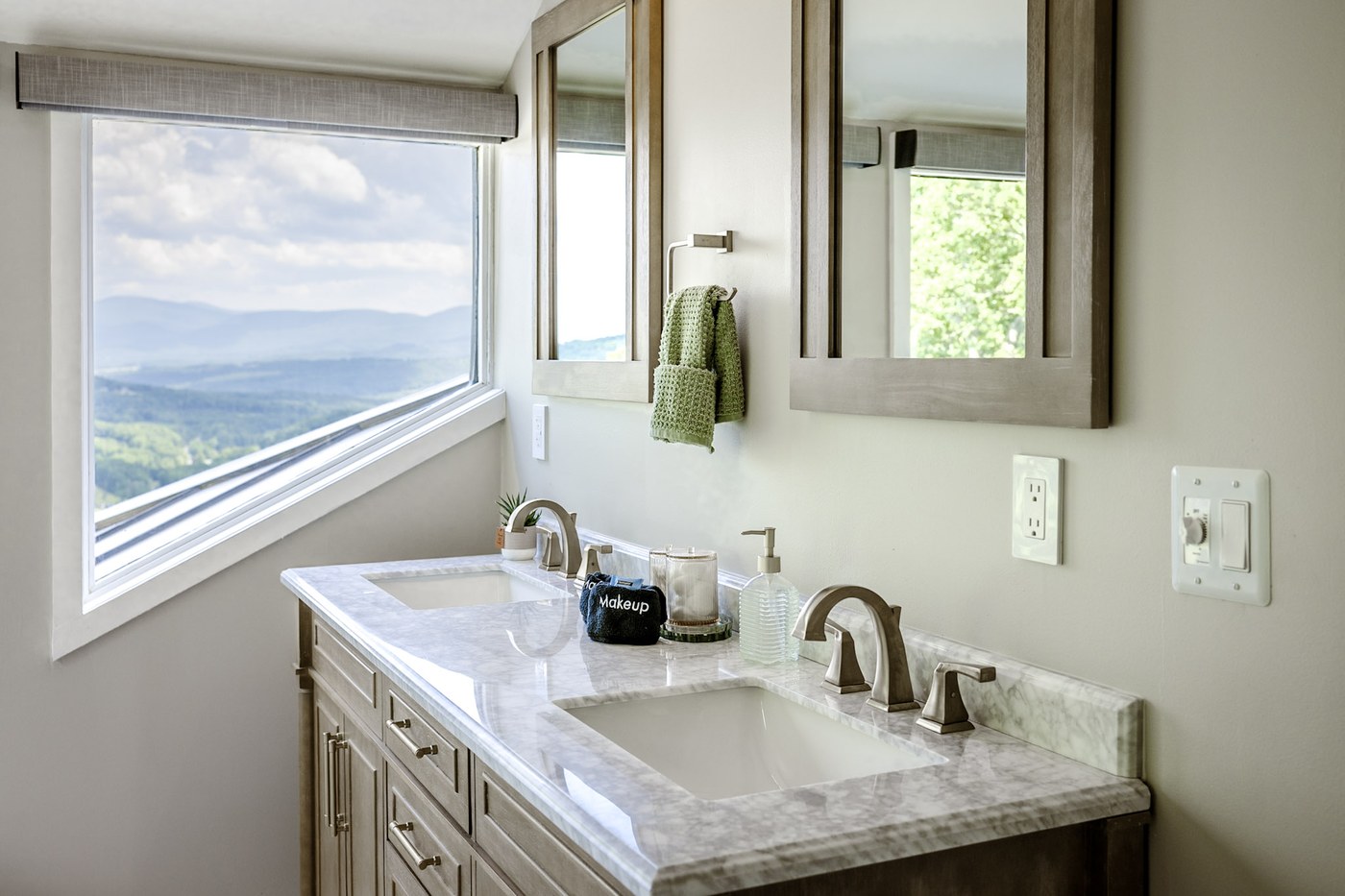 Bathroom vanity detail with brass fixtures and styled counter
