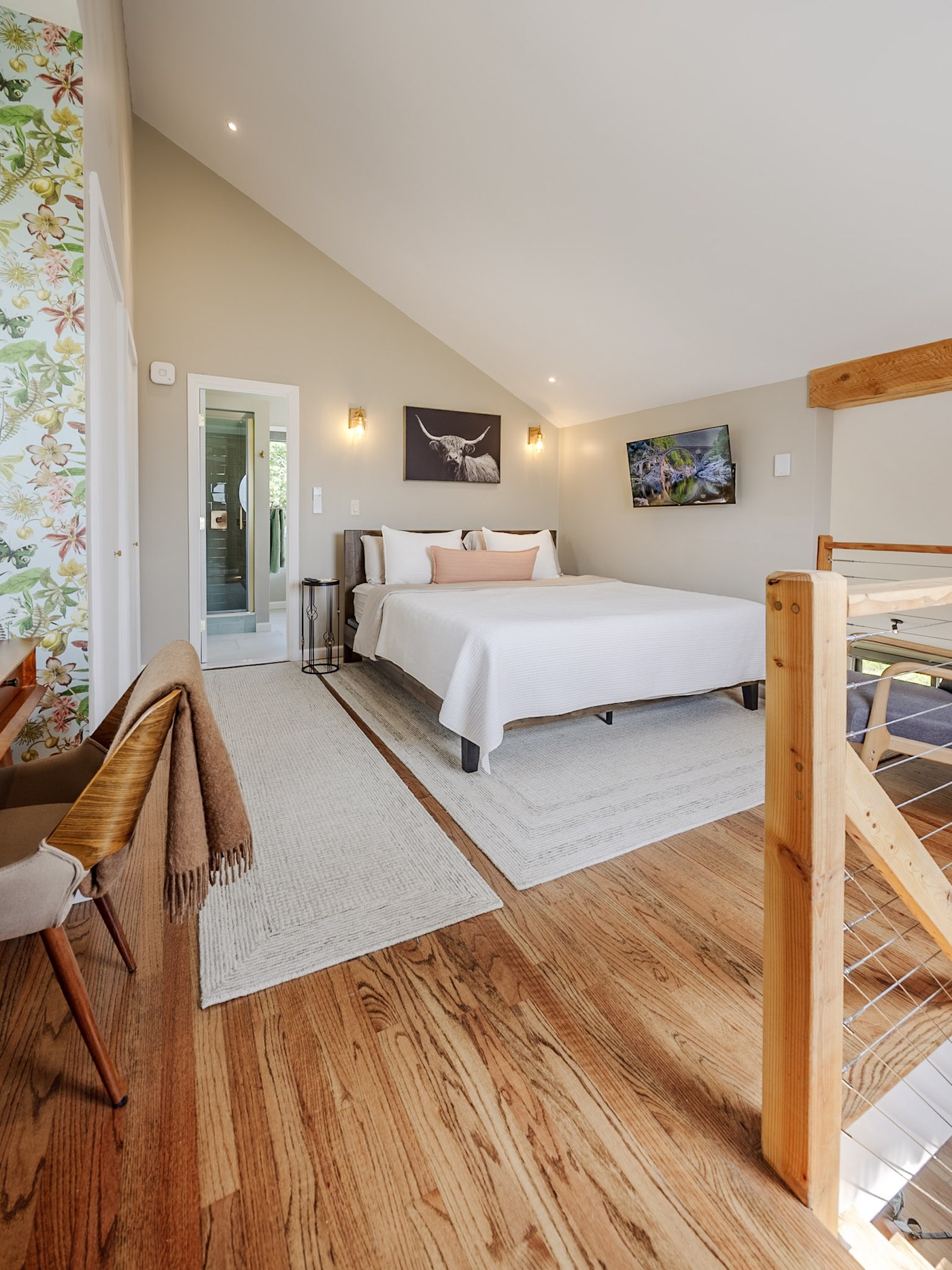 Primary loft bedroom with king bed, wallpaper nook, and Catskill views