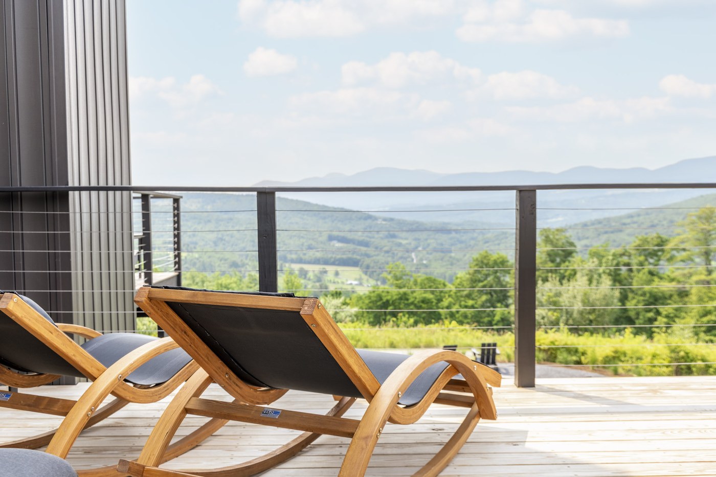 Deck lounge chairs in full sun with sweeping Catskill valley views