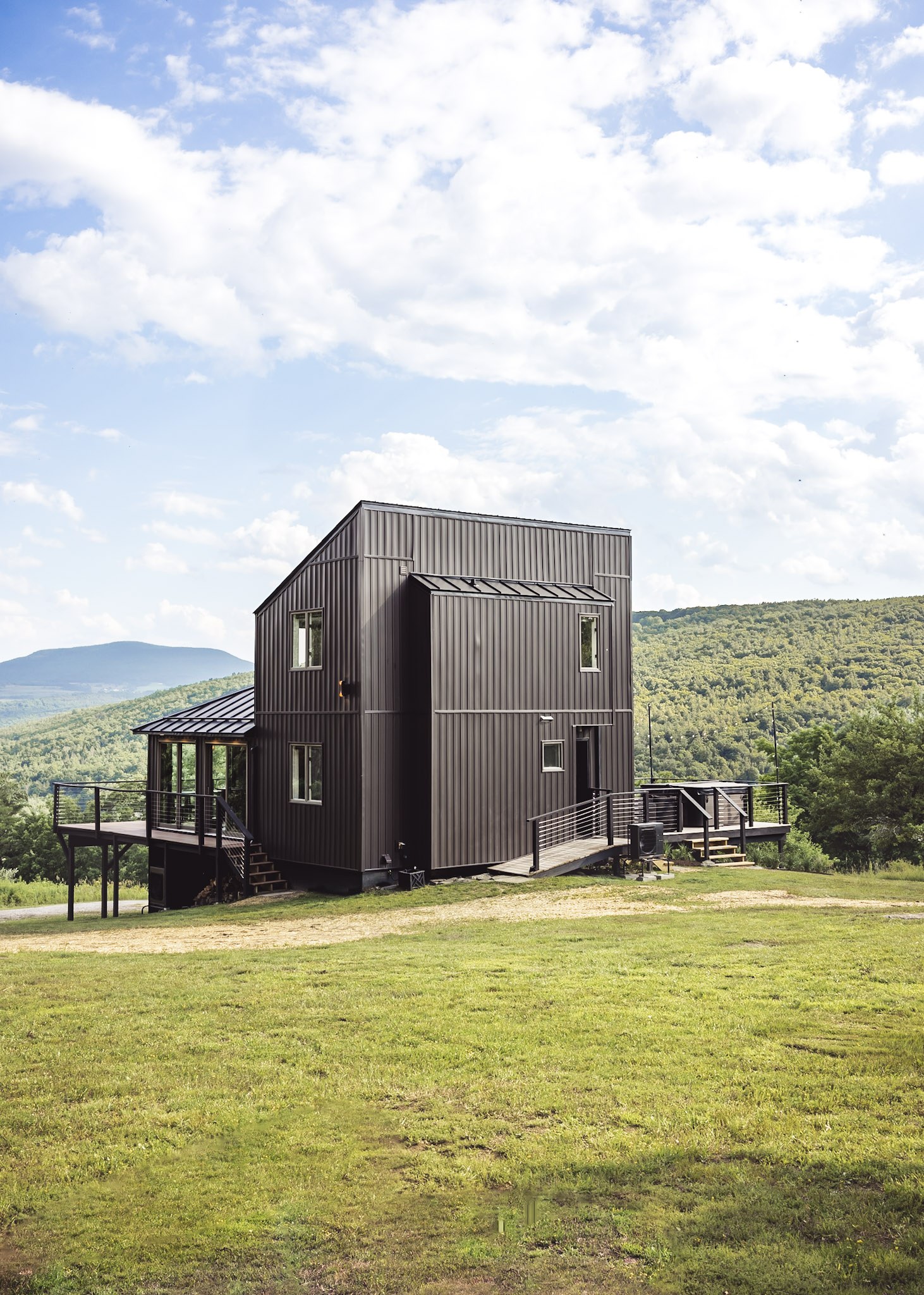 Front view of Hollow Sky — dark contemporary exterior, cable-railed deck, and Catskill mountain backdrop