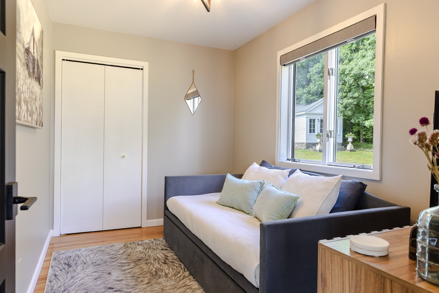 Guest room with daybed and trundle, closet, and window view