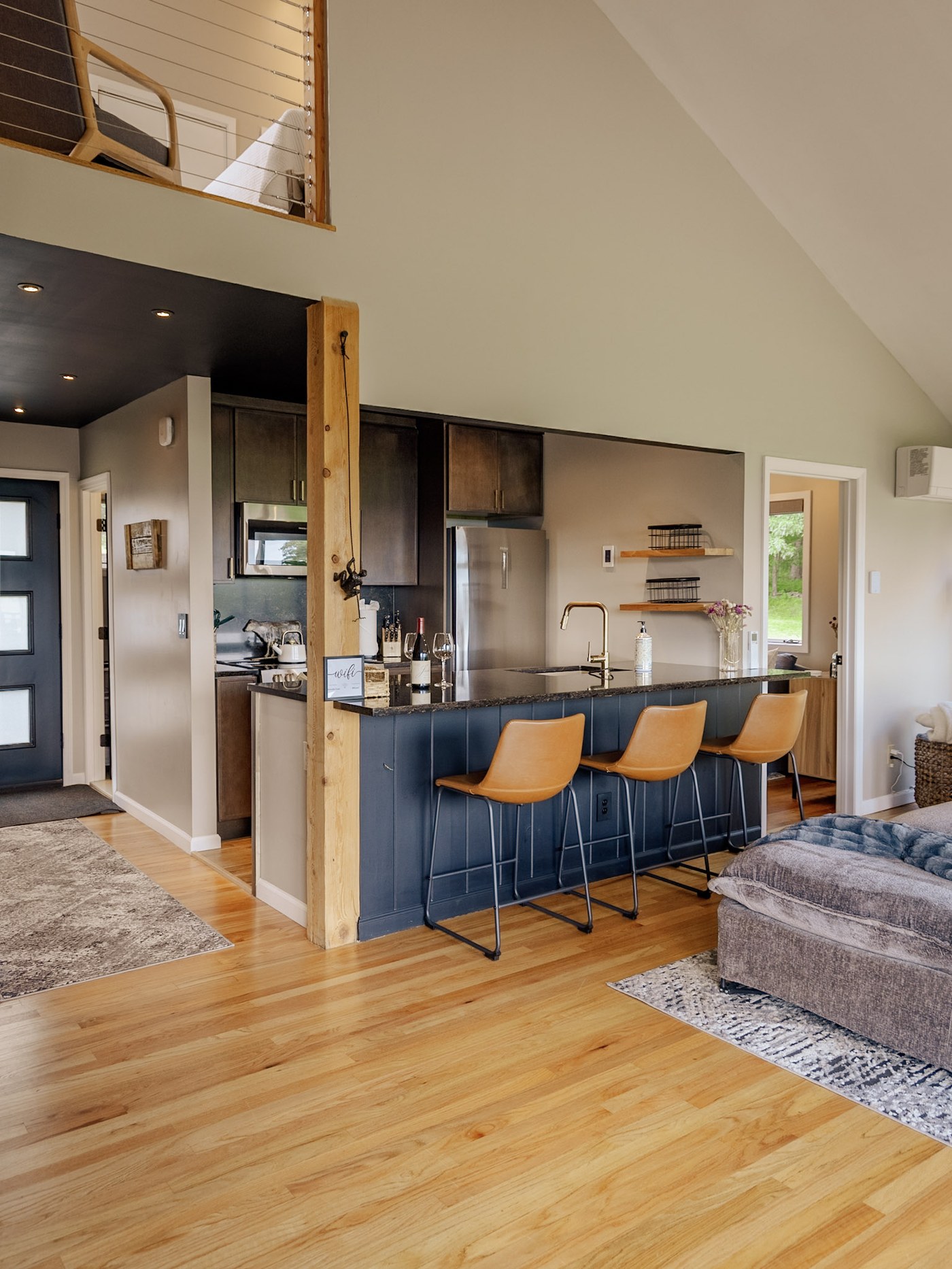 Kitchen with navy cabinetry and brass hardware, vertical view